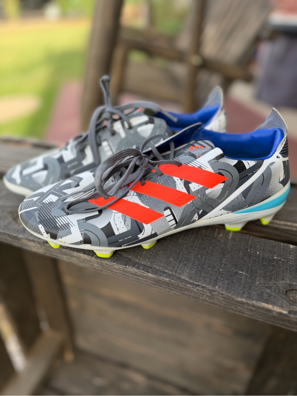 Adidas Men's Gray Graphic Soccer Cleats with Orange Stripes